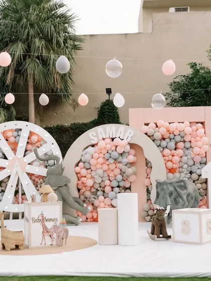 We brought a soft, pastel jungle to life for a little one's first birthday. This wide view showcases the complete themed environment, featuring gentle animal props, custom backdrops, and dreamy balloon installations for a magical celebration.