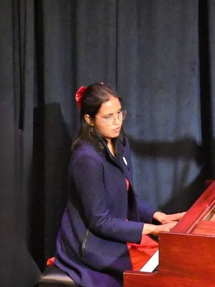 A focused pianist during her classical piece. Our curriculum covers a wide range of musical styles, from classical masterpieces to modern hits.