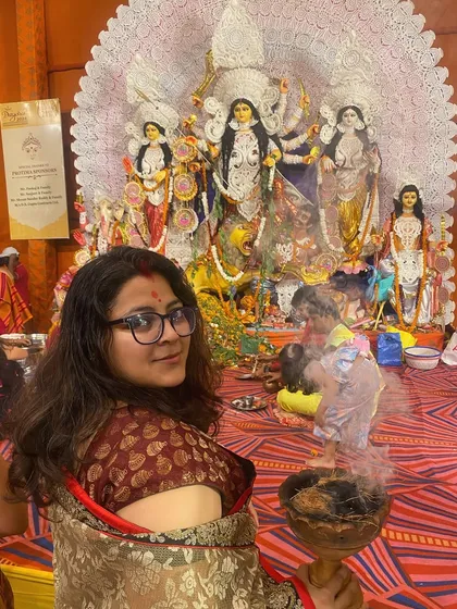 The smoke from the dhunuchi swirls around a devotee, creating a soft, ethereal effect in this portrait taken during the Durga Puja festival.