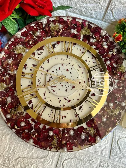 A close-up shot that focuses on the intricate golden clock hands and the delicate pearls scattered among the petals.