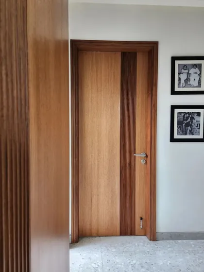 A detail of a custom wooden door, showing the careful combination of different wood grain patterns and textures. Even simple elements are an opportunity for thoughtful design and craftsmanship.
