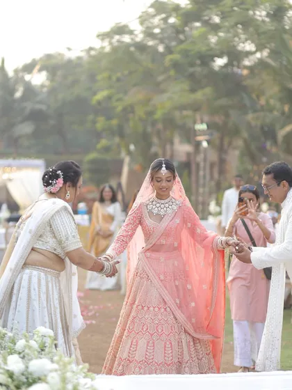 A deeply emotional moment as the bride walks towards her future, holding her parents' hands. We ensure these priceless moments are beautifully framed and captured.