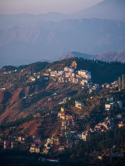A distant view of Shimla's cityscape sprawling across the hills.