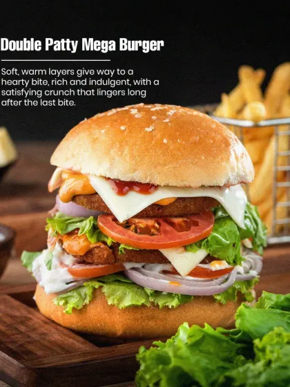 This is our Double Patty Mega Burger, and it's a real handful. We stack two of our signature pure veg patties with fresh lettuce, onions, tomatoes, and cheese in a soft bun. It's the perfect answer for when you're really hungry.