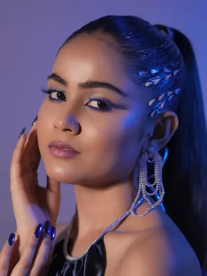 Explore your creative potential with high-fashion and editorial styling. This look, featuring a sleek high ponytail with metallic accents and sharp graphic eyeliner, represents the advanced, trend-setting techniques taught in our workshops.