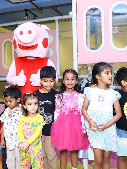 Posing with Peppa Pig. Getting a photo with a favorite character is a highlight of our themed birthday packages.