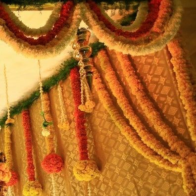 The texture and detail of traditional Indian floral work. We love how the thick garlands of marigolds and tuberoses drape, creating a sense of grandeur for this intimate home celebration.