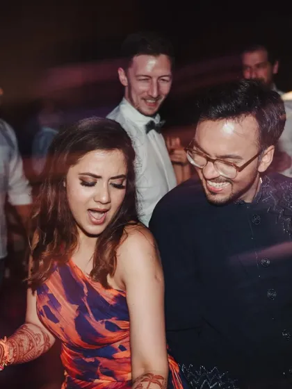 The energy of a Goa beach Sangeet. Friends and family dancing together, capturing the fun, carefree vibe of a destination wedding party.