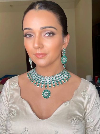 A close-up of the Sangeet look. The soft brown smokey eye and flawless skin create a sophisticated and modern bridal style.