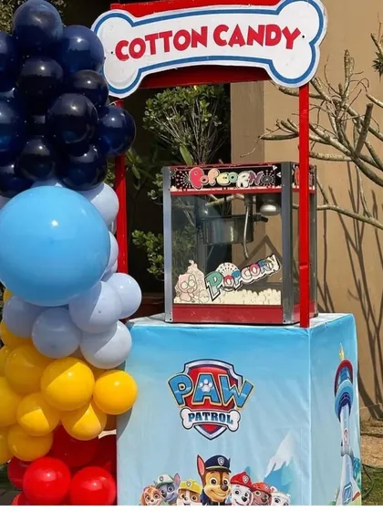 A closer view of the Paw Patrol themed food stall. The branding, colors, and even the bone-shaped sign are all designed to perfectly match the party's theme.