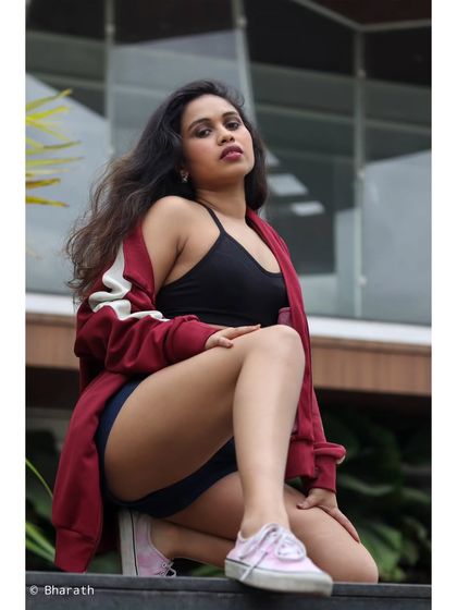 A powerful, low-angle shot that emphasizes the subject's confident pose and athletic style.