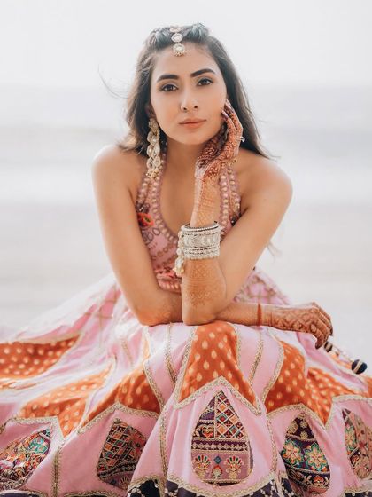 A relaxed and confident bridal portrait on the beach. This shot captures her modern style and the carefree vibe of a destination wedding.