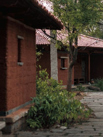 The beautiful mud cottages at Rustic Organic Farm near Bangalore. This eco-friendly stay focuses on sustainability, tradition, and connecting with nature.