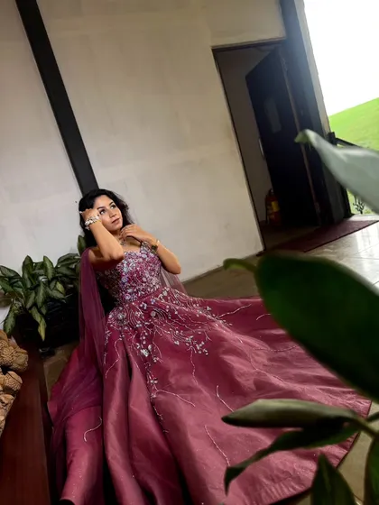 A quiet moment of reflection in a stunning wine-colored gown. This dress is perfect for an elegant indoor engagement or pre-wedding photoshoot.