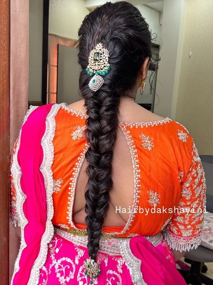 A final look at the stunning fishtail braid, showing how it complements the bride's colorful outfit.