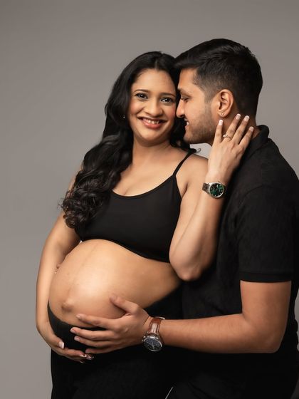 A close-up shot that captures the intimacy and affection between the expecting parents.