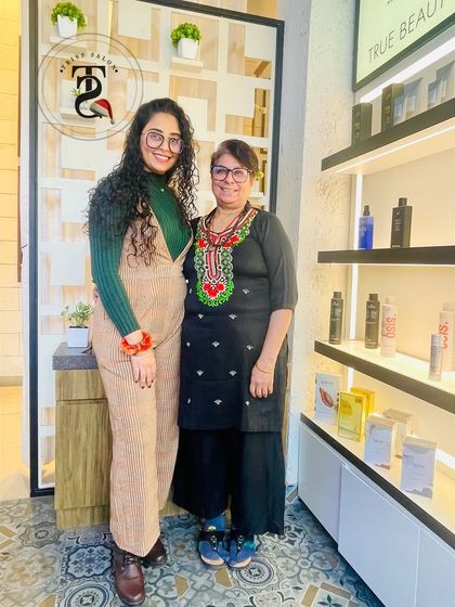 A beautiful mother-daughter moment at the salon. One is embracing her curls while the other gets a fresh haircut, sharing a day of pampering together.