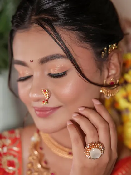 Eyes closed to show the subtle, shimmery eyeshadow that catches the light beautifully.