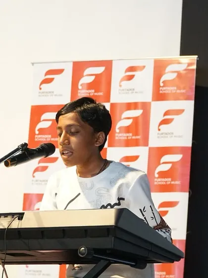 A student performs a vocal and keyboard piece at the Chembur showcase. We encourage multi-talented students to showcase all their skills, fostering well-rounded musicianship.