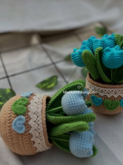 Our crochet tulip pots in shades of blue. We love experimenting with different color combinations to create unique pieces for you.