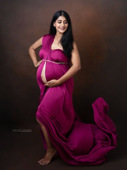 A graceful pose from a mother-to-be in a flowing gown. This shot captures the elegance and beauty of the final weeks of pregnancy.