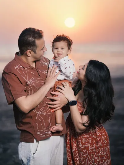 A warm family portrait on the beach during golden hour. The soft light and genuine smiles create a feeling of love and connection.