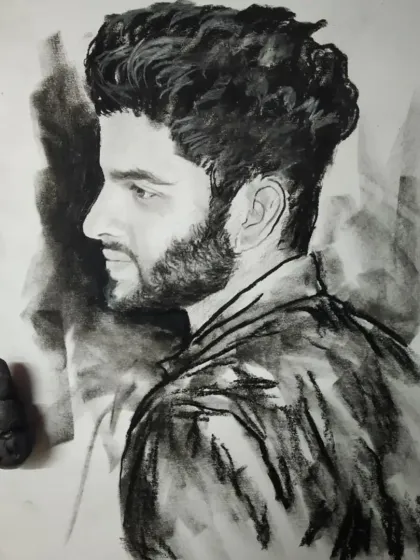 A charcoal sketch of a man in profile. The dramatic lighting and rough texture give this piece a very masculine feel.