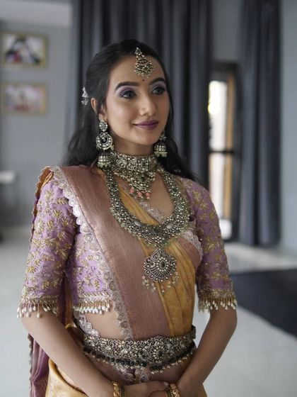 A candid indoor shot showing the elegant half-up hairstyle and the beautiful oxidized earrings.