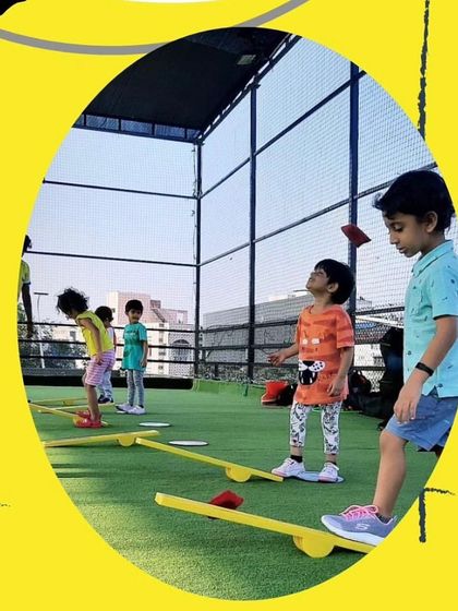 Balance is a fundamental skill for all sports. In this photo, you can see our campers carefully navigating balance beams on the turf, an activity that improves focus, concentration, and core stability.