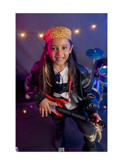 A portrait of our little rockstar, full of energy and a toothy grin.