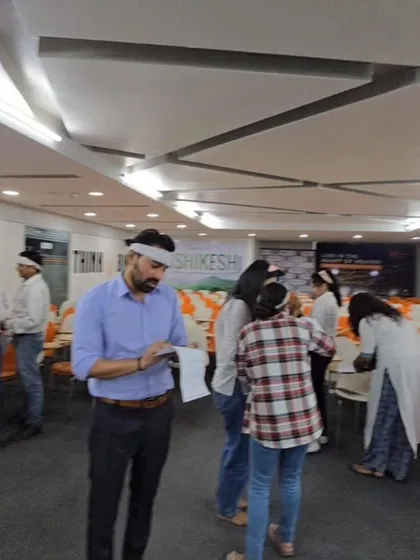Participants engaged in a blindfolded communication exercise. Activities like these are designed to improve listening skills, build trust, and highlight how clear instructions are vital for team success.