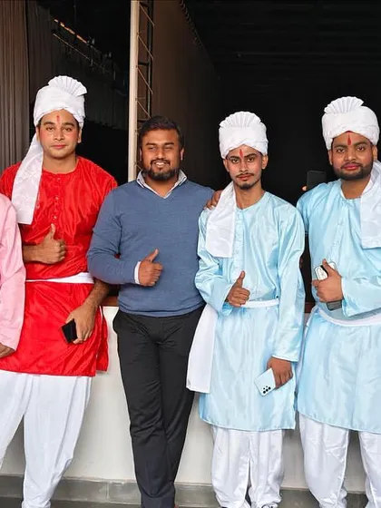 The full team of performers in their vibrant costumes. I direct large group numbers that create a powerful visual impact for corporate stage shows.