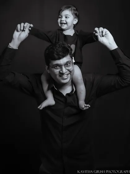 A classic black and white portrait of a father and his child. This timeless style removes all distractions, focusing purely on the strong, happy bond they share.