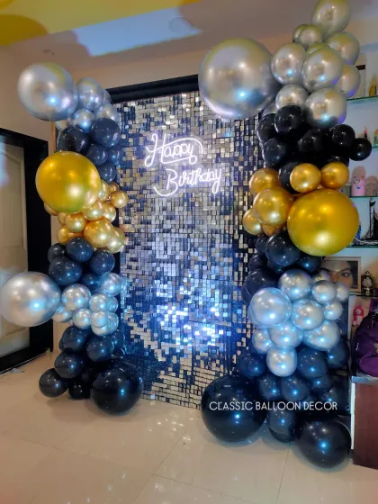 Our shimmer sequin backdrops are perfect for creating a glamorous photo booth at any birthday party or event. We frame the sparkling wall with a custom balloon arrangement in black, gold, and silver, and add a 'Happy Birthday' neon sign for that extra pop.