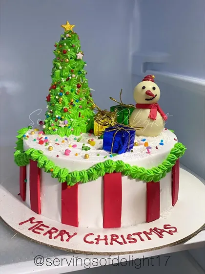 My custom Christmas cake, complete with a buttercream Christmas tree and a cute snowman. A festive centerpiece for your holiday celebration.