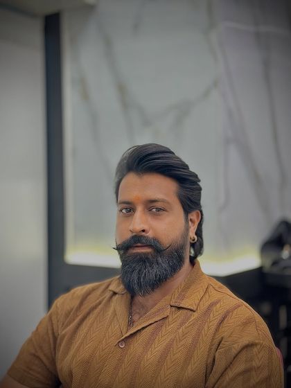 This client's classic haircut is perfectly complemented by his impressive beard and mustache.