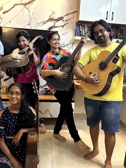 The adult jam session crew, striking a pose with their guitars. Music is for everyone, at any age.