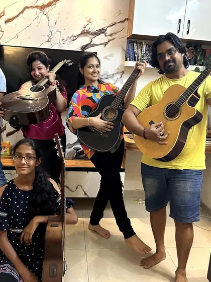 The adult jam session crew, striking a pose with their guitars. Music is for everyone, at any age.