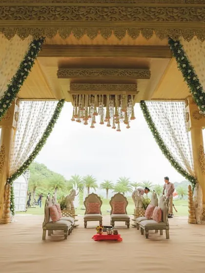 A majestic mandap set against the serene hills of Udaipur. I design wedding ceremonies that are not just visually stunning but also deeply personal and grand in scale.