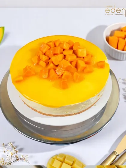 A closer look at our classic Mango Cheesecake, topped with a generous amount of fresh, diced mango for a burst of flavor in every bite.