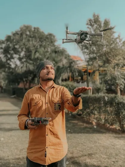 Here I am with my DJI Air 2S drone, my trusted partner for capturing stunning aerial views. It's important for you to see the person behind the controls, ready to bring your vision to life.