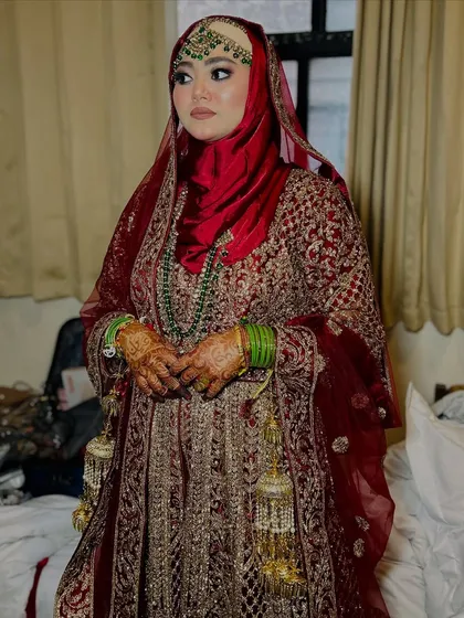 A full-length view of the Hijabi bride, showing how the entire look, from the makeup to the hijab and the lehenga, comes together to create a stunning silhouette.