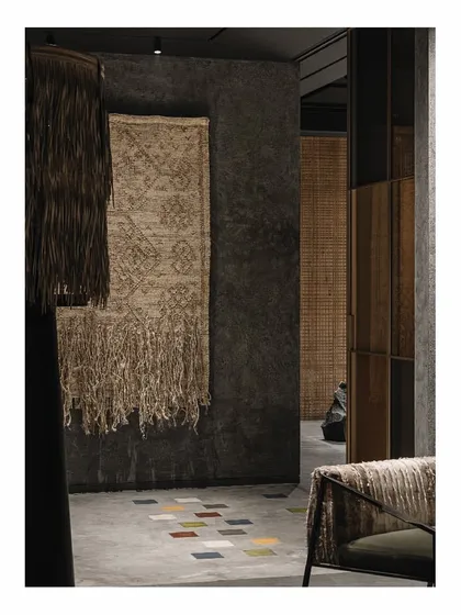 The Zen garden spaces in the 'Frozen' store each contain a unique, obscure object, like this hanging textile art. These elements create curiosity and conversation, turning a retail space into a gallery of interesting forms and textures.