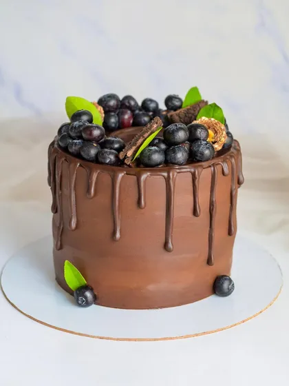 My Ultimate Chocolate cake paired with fresh blueberries. The tartness of the berries cuts through the richness of the dark chocolate ganache, creating a perfect flavor combination.