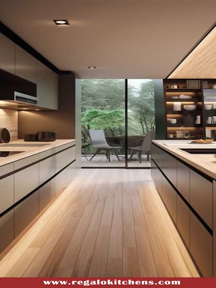 This parallel kitchen design uses dark cabinets and under-cabinet lighting to create a moody and sophisticated atmosphere. The layout is highly efficient, with a large window at the end opening up to a green view.