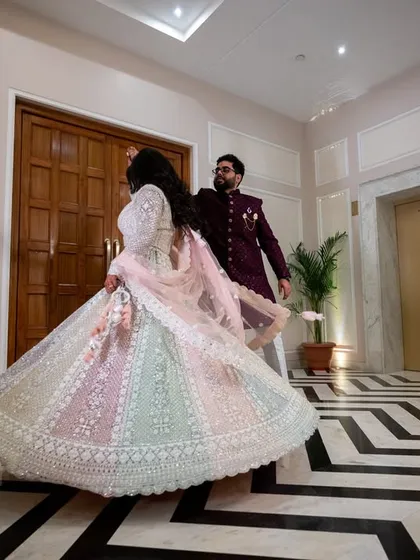 A beautiful motion shot of the bride twirling in her multi-colored lehenga. The movement adds life and energy to the photo.