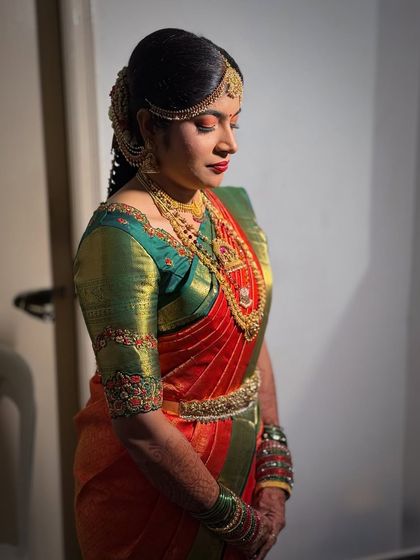 A side profile showcasing Prerna's complete Muhurtham look, including her elegant hairstyle and jewelry.