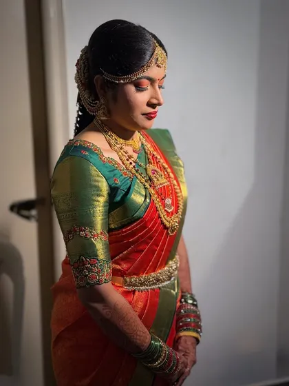 A side profile showcasing Prerna's complete Muhurtham look, including her elegant hairstyle and jewelry.