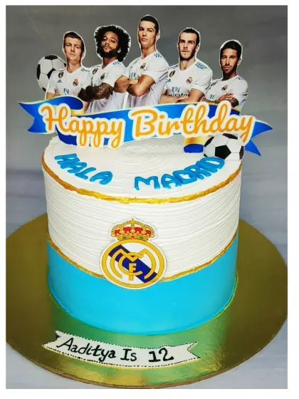 A Real Madrid football cake for a 12th birthday. This butterscotch cake is decorated with the team's logo and star players.