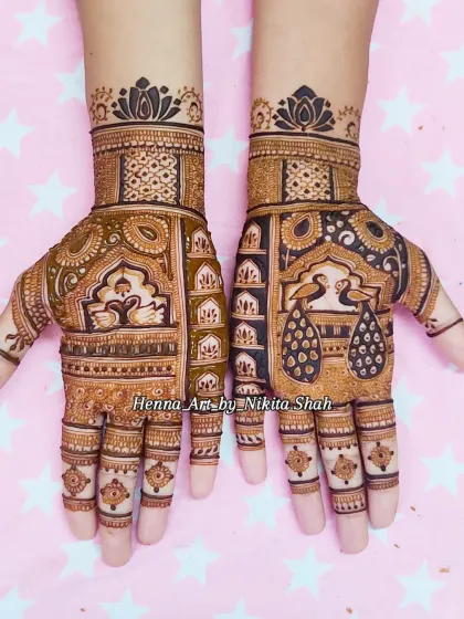 A symmetrical design showcasing the beauty of light and dark henna work. The peacocks are the centerpiece, surrounded by detailed jaali (net) and floral patterns.